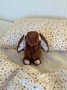 a stuffed animal sitting on top of a bed