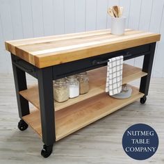 a kitchen island with butcher block top on wheels