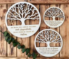 two wooden plaques with trees and names on them