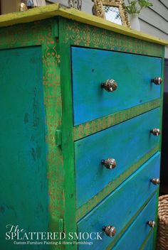 an old dresser is painted bright green and gold