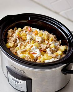 a crock pot filled with food sitting on top of a table