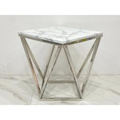 a white marble top side table with metal frame legs and square base, in a room