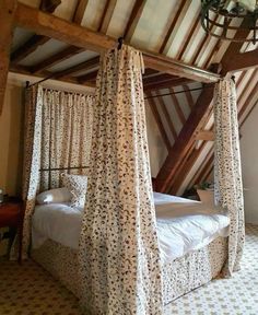 a canopy bed sitting in the middle of a bedroom