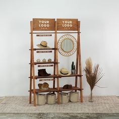 two wooden shelves with hats and other items on them next to a potted plant