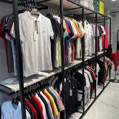 an assortment of shirts on display in a clothing store