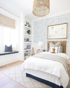 a bed room with a neatly made bed and shelves