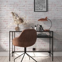 a brown chair sitting in front of a table with a lamp on it next to a brick wall