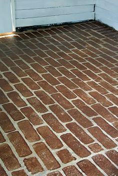 a red brick floor in front of a white door