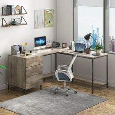 an office with a desk, chair and computer on it in front of a large window