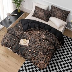 a bed with black and gold comforter on top of it