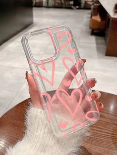 a person holding up a clear case with pink writing on it that says i love you