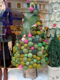 a display in a store window filled with balls of yarn