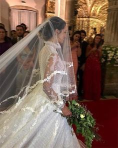 the bride is getting ready to walk down the aisle with her veil over her head