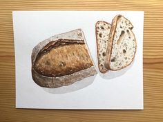 a piece of bread is cut in half and placed on top of a piece of paper