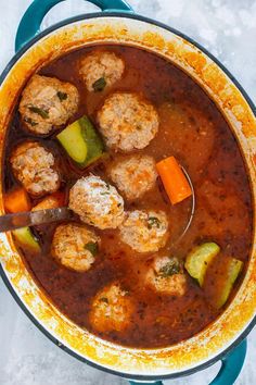 a pot filled with meatballs and vegetables