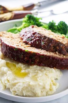 meatloaf, mashed potatoes and broccoli sit on a white plate