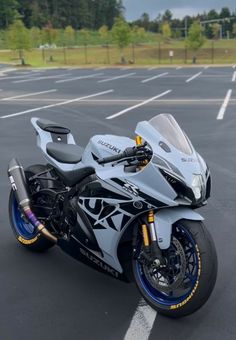 a white and blue motorcycle parked in a parking lot