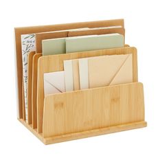 a bamboo desk organizer with several folders in it