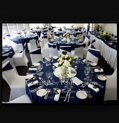 the tables are set with white and blue linens