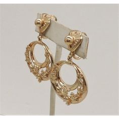 This is part of Chairish’s Costume Jewelry assortment.  1950s Edwardian style goldtone scrollword hoop clip back earrings. Marked "Napier." Measure:  2 inches long by 1 1/8 inches wide. Condition: Very good; minor surface wear to backs. Identical earrings except in silvertone are shown on pg. 253 of Melinda L. Lewis & Henry Swen's book "The Napier Co.: Defining 20th Century American Costume Jewelry."  Please reference the measurements noted in the description above for the best approximate dimen American Costume, Edwardian Style, Edwardian Fashion, Accessories Jewelry Earrings, Clip Earrings, Vintage 1950s, Costume Jewelry, Clip On Earrings, 20th Century