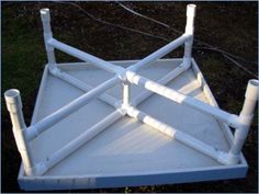 an old white wooden bed frame with pipes attached to the top and bottom posts on each side