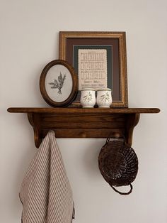 a shelf that has some items on it with a clock and other things in front of it