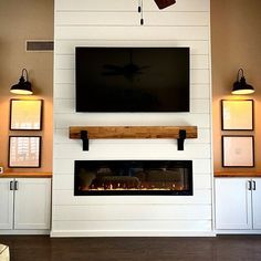 a flat screen tv mounted on the wall above a fireplace