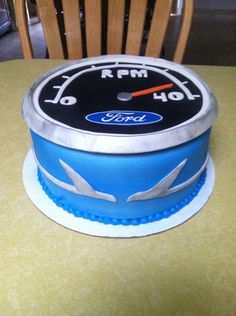 a cake that is sitting on top of a table with a speedometer on it