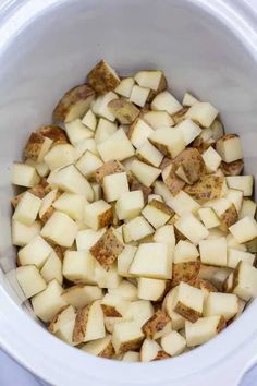 cooked potatoes in a white bowl ready to be put into the crockpot or slow cooker