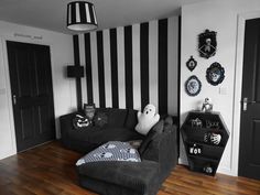 a living room with black and white striped walls