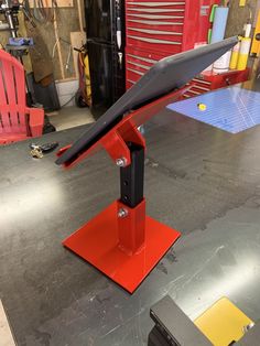 a red metal stand on top of a table