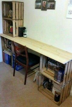 a wooden desk sitting next to a book shelf filled with books on top of it