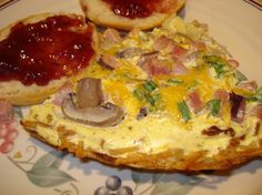 an omelet with mushrooms, ham and cheese on it