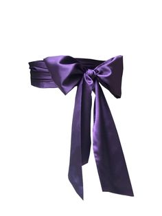 a purple bow tied to the side of a headband on top of a white background