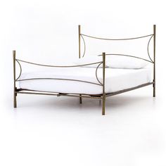 a metal bed frame with white sheets and pillows on it, against a white background