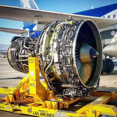 an airplane engine sitting on top of a yellow cart