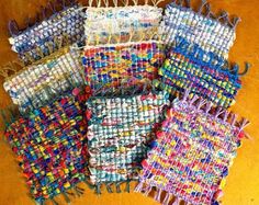 several pieces of woven fabric sitting on top of a wooden table next to each other