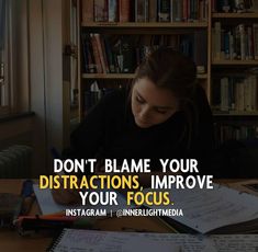 a woman sitting at a table with books and writing on it, in front of a bookcase