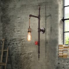 an industrial style light fixture hanging from the side of a wall