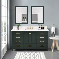 a bathroom with two mirrors above the sinks and a rug on the floor next to it