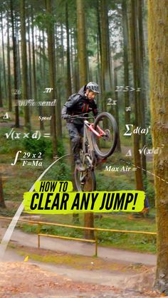 a man on a bike jumping over a jump in the woods with words surrounding him