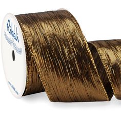 a spool of gold metallic foil on a roll of wired ribbon with a white background