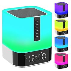 an alarm clock radio sitting on top of four different colored cube shaped speakers with the time displayed