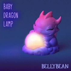 a baby dragon lamp sitting on top of a purple cloud with the words baby dragon lamp above it