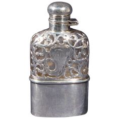 an ornate silver flask bottle is shown on a white background