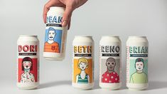 a hand is holding a can with four different types of beer in it and the bottom one has an image of a man's face on it