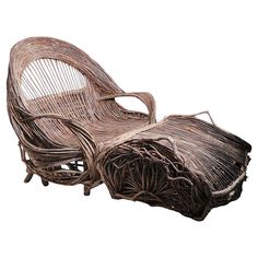 a wicker lounge chair and ottoman made out of branches