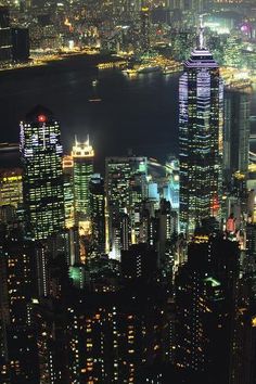 an aerial view of the city lights at night from high up in the skyscrapers