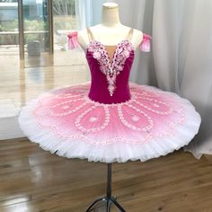 a pink and white ballerina dress on a mannequin