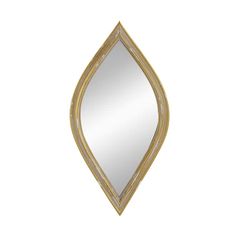 a gold leaf shaped mirror on a white wall